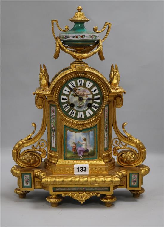 A French gilt painted clock, with porcelain panels